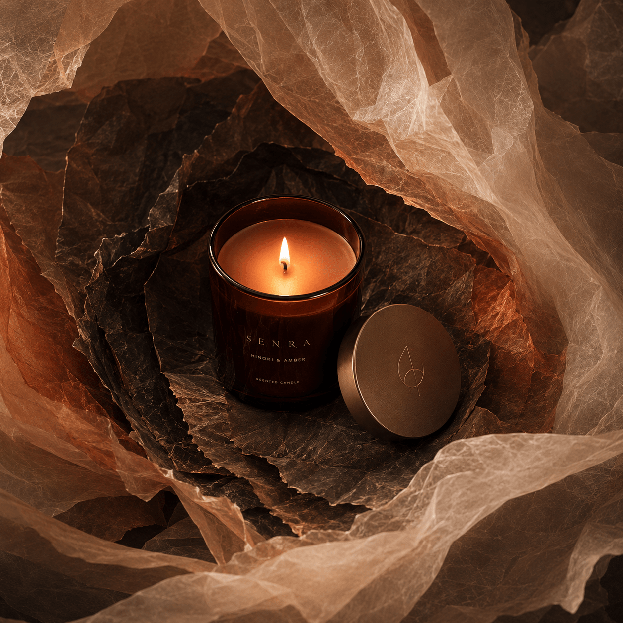 SENRA Hinoki & Amber scented candle inside an Ember Veil paper world